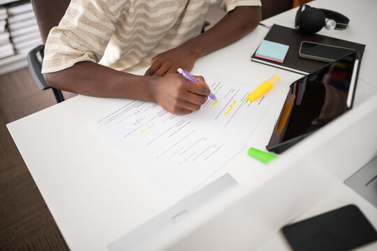 Anonymous student studying at library desk