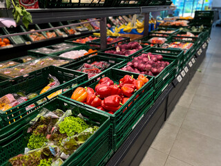 Various fresh vegetables on shelves at a grocery store