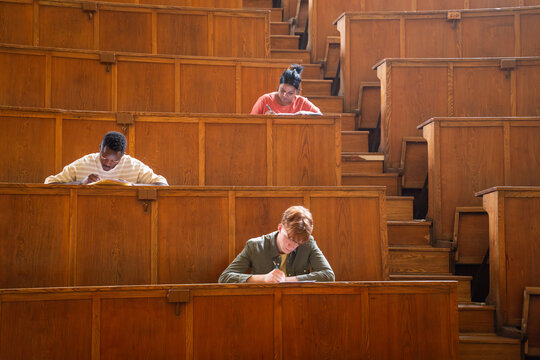 Students at wooden university auditorium