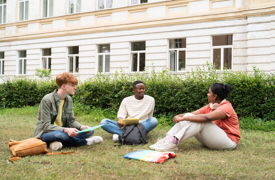 Students conversation on lawn outside dorm