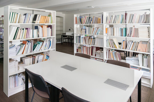 Modern library study area with filled bookshelves