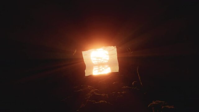 Heading out of the dark cave towards an epic sunrise. The gates of the tomb swung open and let in the rays of bright sunshine into the darkness