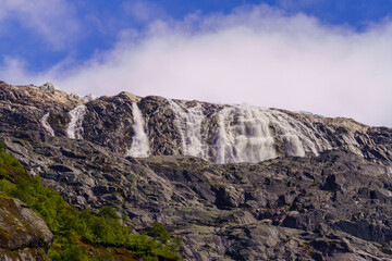 Majestic Glacial Waterfall Cascading Down Rocky Cliffs in the Norwegian Highlands