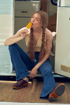 Woman Eating Popsicle by Camper Van
