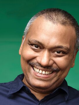 Happy expression of an middle aged Indian man  with toothy smile