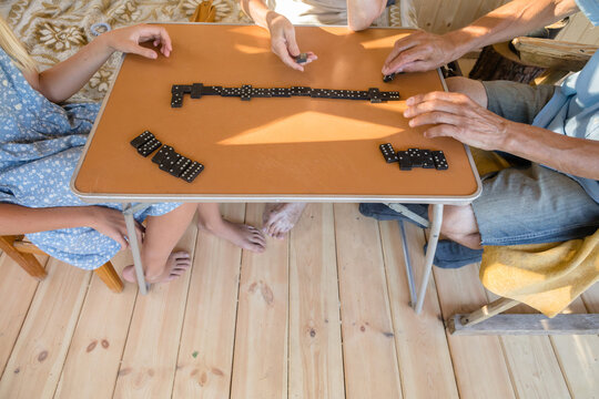 Close-up of hands playing dominoes game