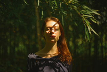 A young woman in a bamboo shadow