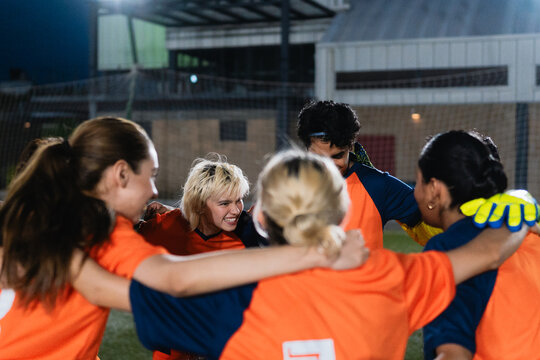Sport team in a huddle before playing in a match.