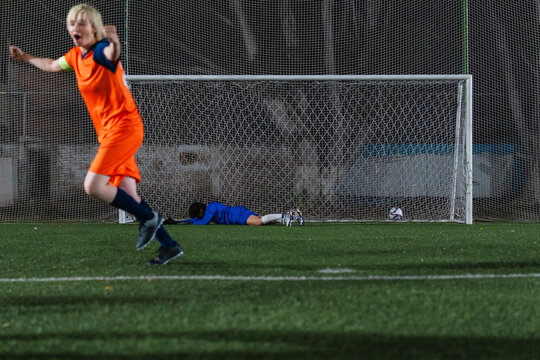 Football player scoring a penalty kick.