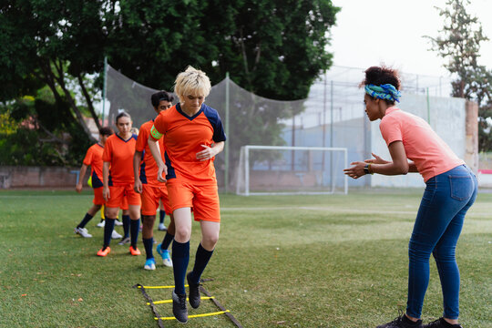 Young soccer team training with their coach.