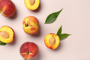 Sweet peaches and leaves on beige background