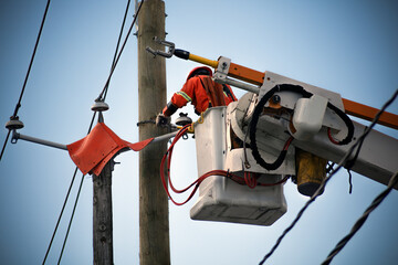 Electricity Line Worker Repairing Power Lines Using Aerial Platform