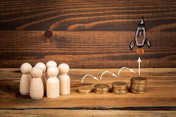 Earnings benefits and retirement plan concept.  Money and miniature figures on a wooden background