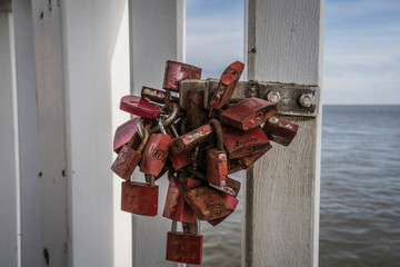 Love padlocks on a railing on the seaside.