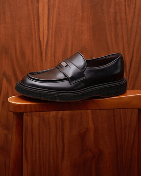 Black Leather Penny Loafer on Wooden Stool