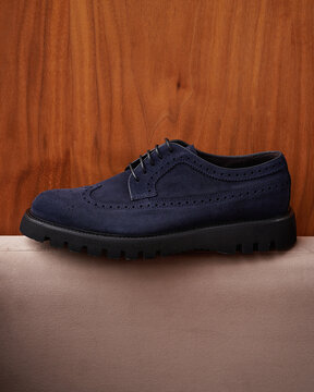 Blue Suede Brogue Shoe on Wood Background