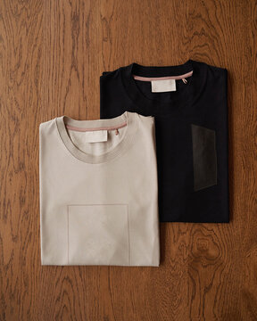 Two T-shirts on Wooden Table