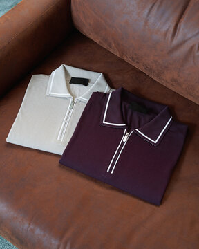 Two Zip-Up Polos on Leather Couch
