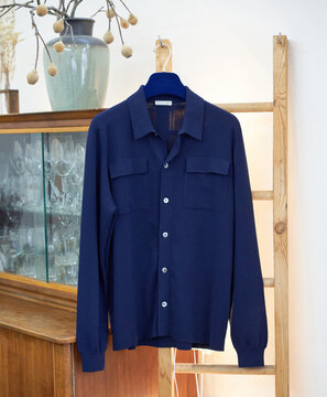 Navy Blue Knit Shirt on Wooden Hanger