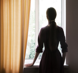 Praying woman at the window