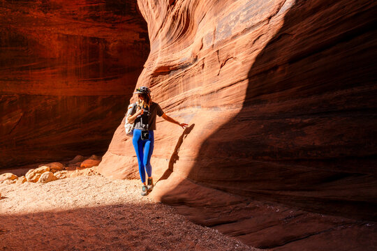 Woman exploring slot canyon