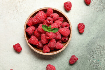 Bowl with fresh raspberry and mint on light background, closeup