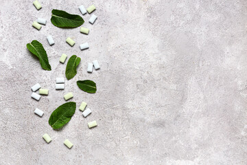 Fresh chewing gums with mint on grey background