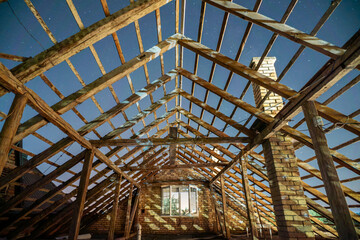 Open house roof at night. Attic construction