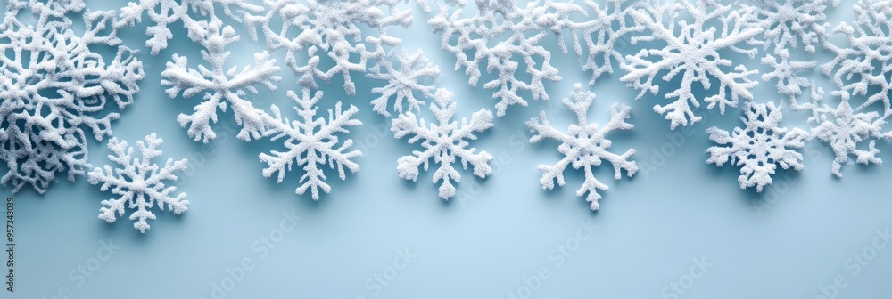 Poster delicate white snowflakes display intricate patterns against a gentle blue gradient. this compositio