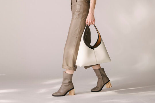 Stylish Woman Holding an Elegant White Handbag