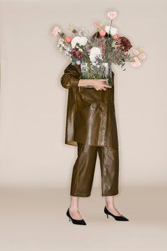 Woman Holding Vase Of Colorful Flowers In Stylish Outfit