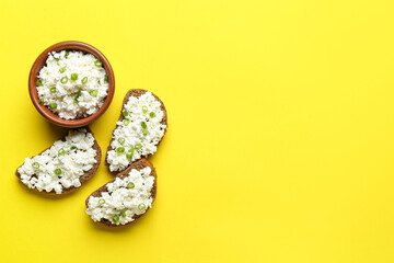 Tasty sandwiches with cottage cheese on yellow background