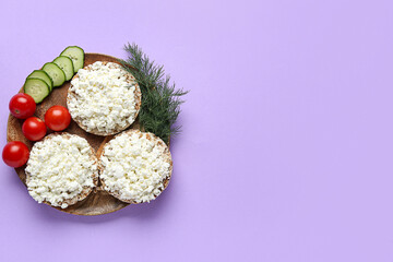 Tasty rice cakes with cottage cheese and vegetables on lilac background