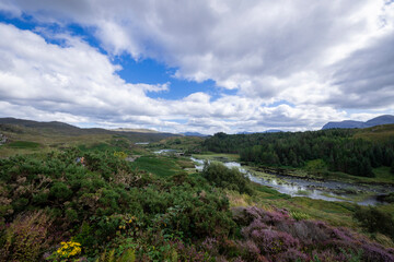 Obraz premium The image shows a body of water surrounded by hills in Loch a' Chàirn Bhàin, Scotland. The scene includes clouds, nature, water, sky, mountains, and a highland landscape.
