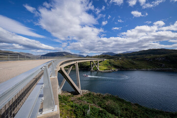 The image is of the Kylesku Bridge in Scotland, which spans Loch a' Ch&agrave;irn Bh&agrave;in in Sutherland. It is a concrete bridge. 