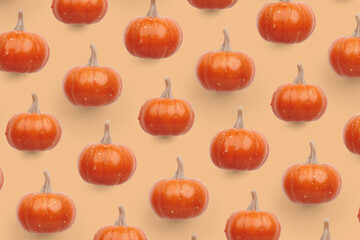 Orange pumpkin pattern on pastel color background