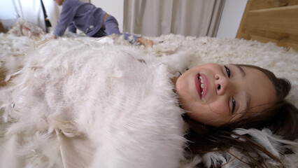 Happy Children Having A Pillow Fight, Covered In White Feathers, Laughing And Playing On A Bed, Capturing The Essence Of Childhood Fun And Sibling Bonding In A Cozy Home Setting