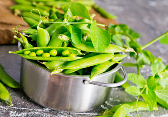 Green peas in metal bowl