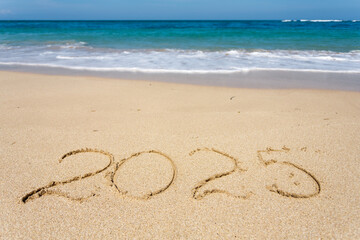 New Year 2023, lettering on the beach with wave
