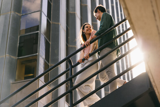 Couple ascending stairs in Azca, Madrid on a sunny day