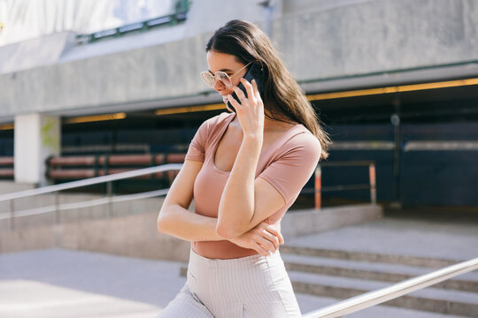 Young woman talking on the phone in Azca urban area of Madrid