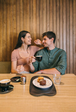 Couple enjoying coffee and pastries in a cozy cafe