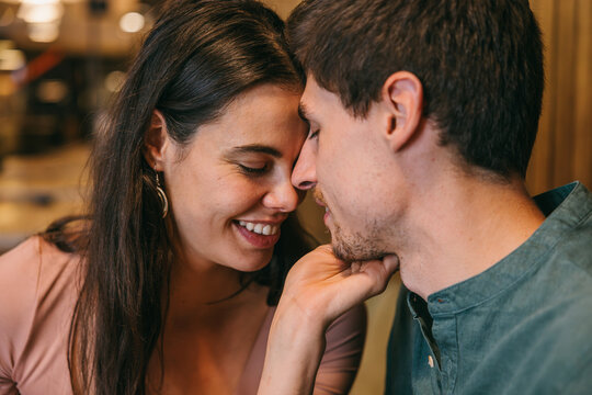 Couple sharing an intimate moment in a cozy setting