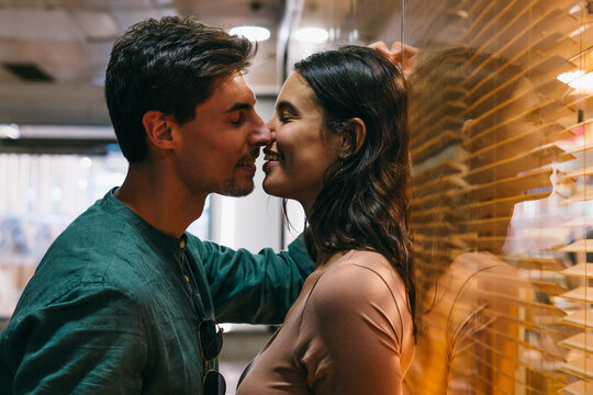Young couple sharing an intimate moment in Azca, Madrid