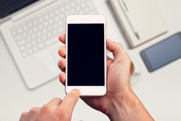 Hand typing on smartphone with blank screen