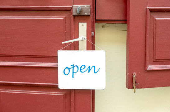 Open sign on the door handle of a cafe or shop