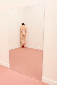 Woman Reflecting In A Mirror In Modern Minimalist Space