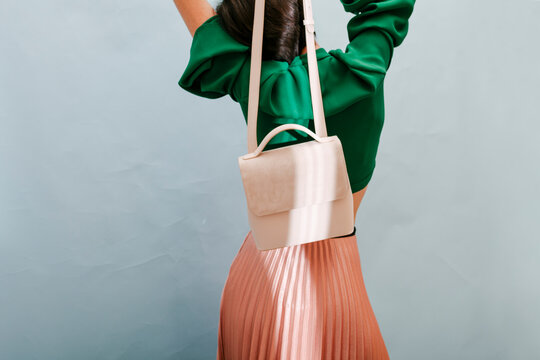 Stylish Woman Posing with Trendy Nude Handbag and Fashion Outfit