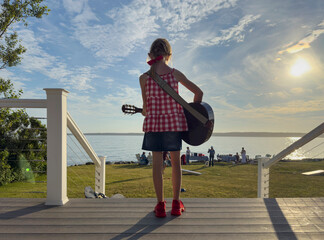 UGC Young Girl Playing guitar at summer lifestlye party in Maine 
