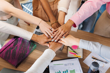 Colleagues in the office palming hands.